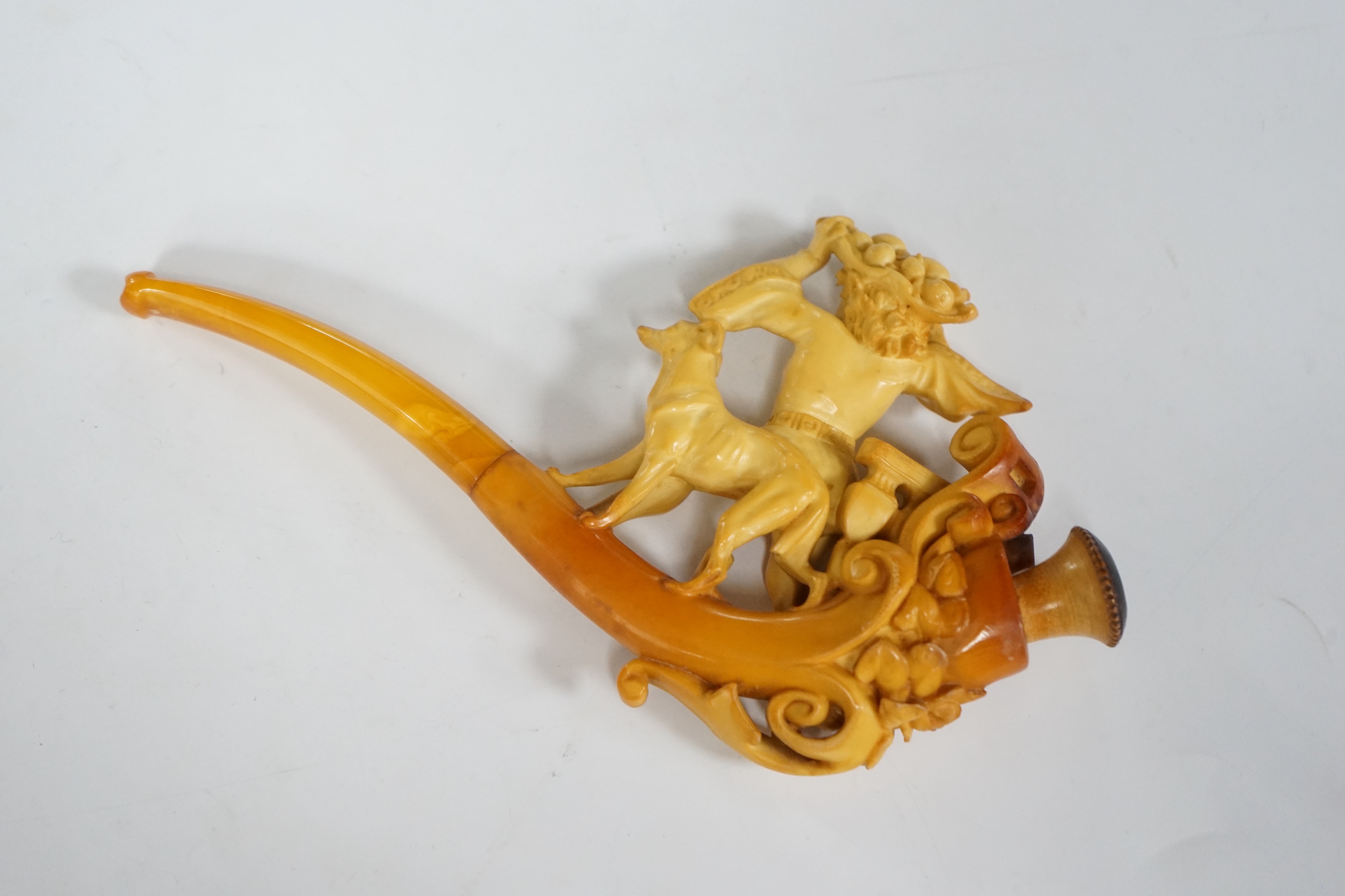 A cased Meerschaum pipe, the bowl in the form of a 17th century huntsman with his dog, 19cm long